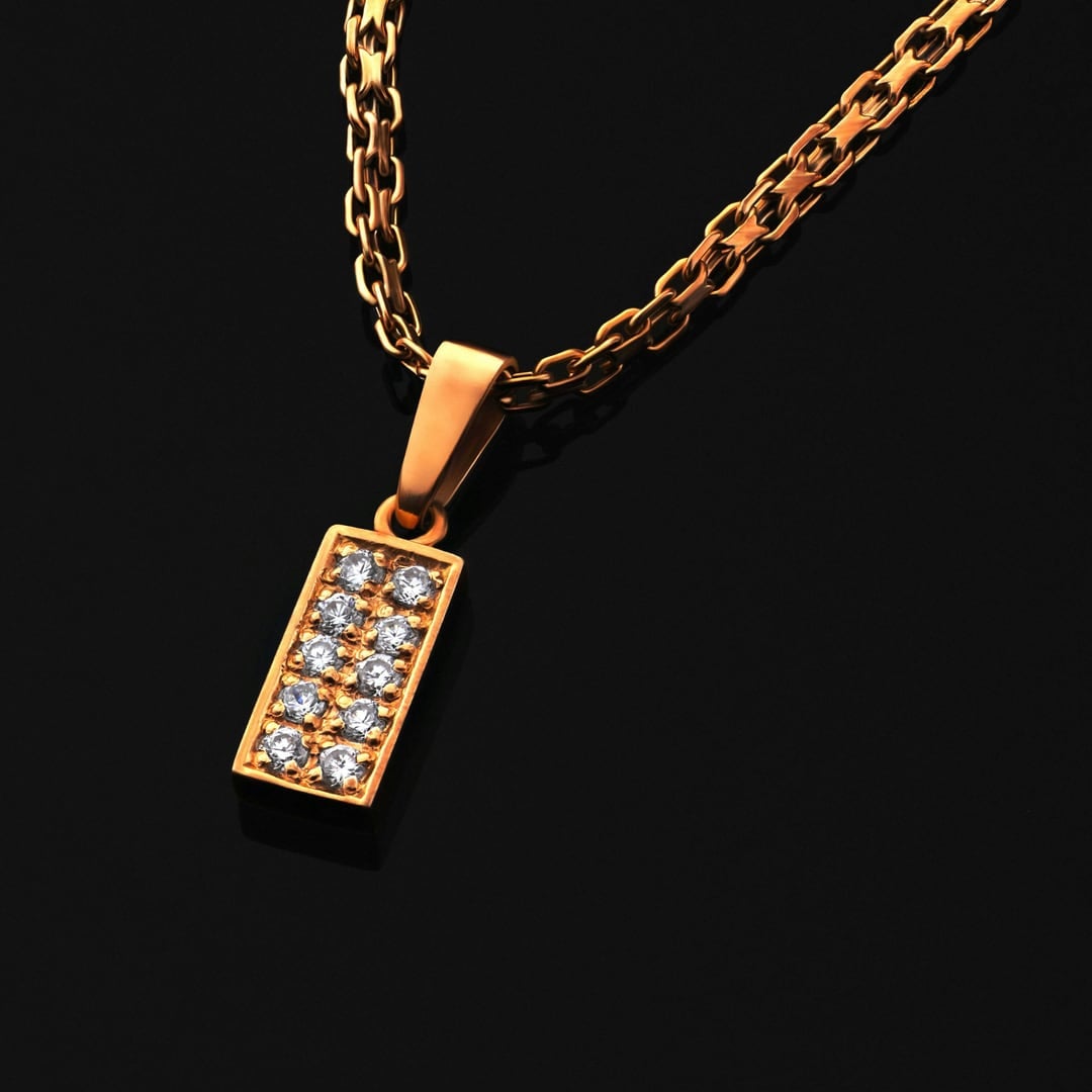 Gold chain necklace with a rectangular pavé diamond pendant against a black background