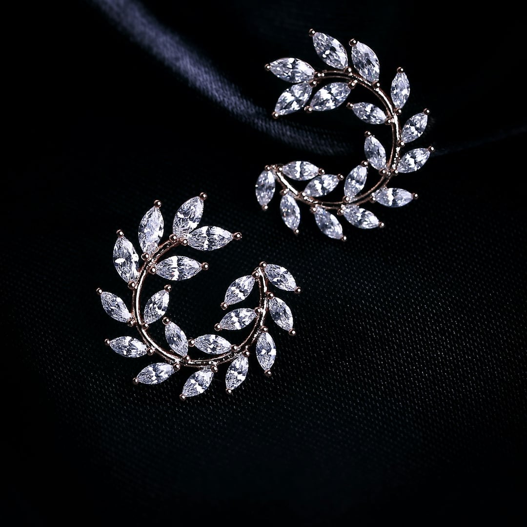 Laurel wreath earrings set with marquise diamonds on black velvet